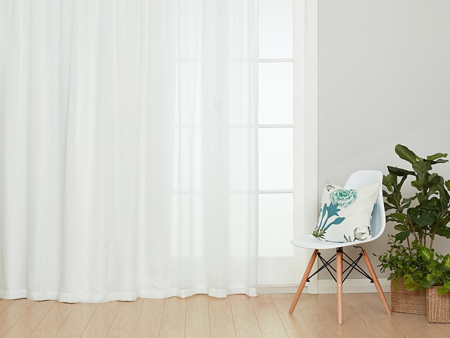 Sheer Curtains Create a Continuous Backdrop That Anchors Your Room