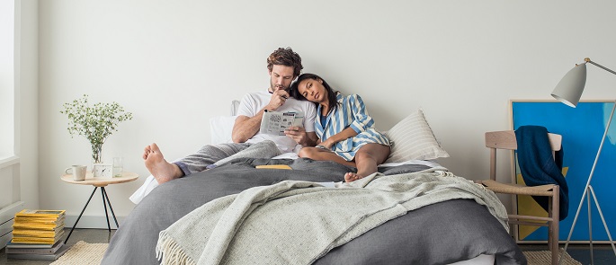 couple sitting on a king size mattress