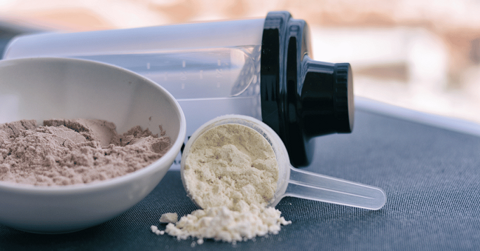 scoop of protein powder and a shaker