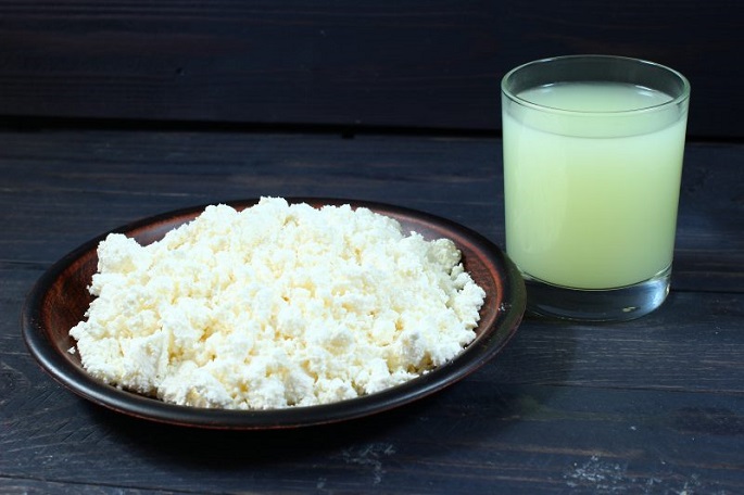a plate of curd and a glass of whey