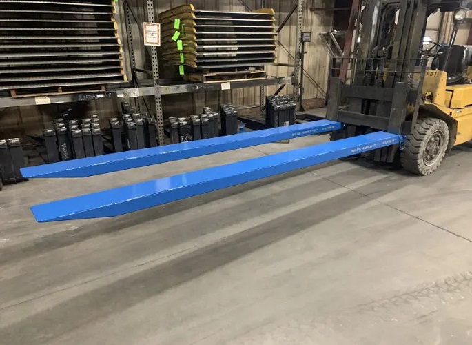 Forklift with fork extensions in a warehouse