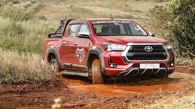 toyota hilux fiftted with aftermarket stuff offroading in the mud terrain