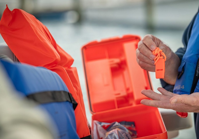 man checking the safety equipment in the boat
